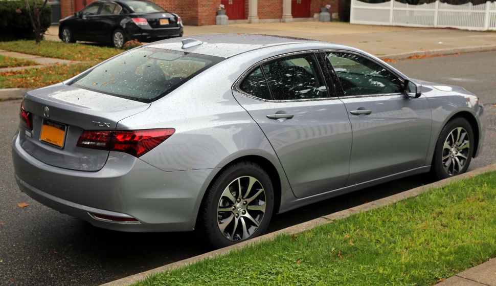 Silver sedan rear side view with alloy wheels.
