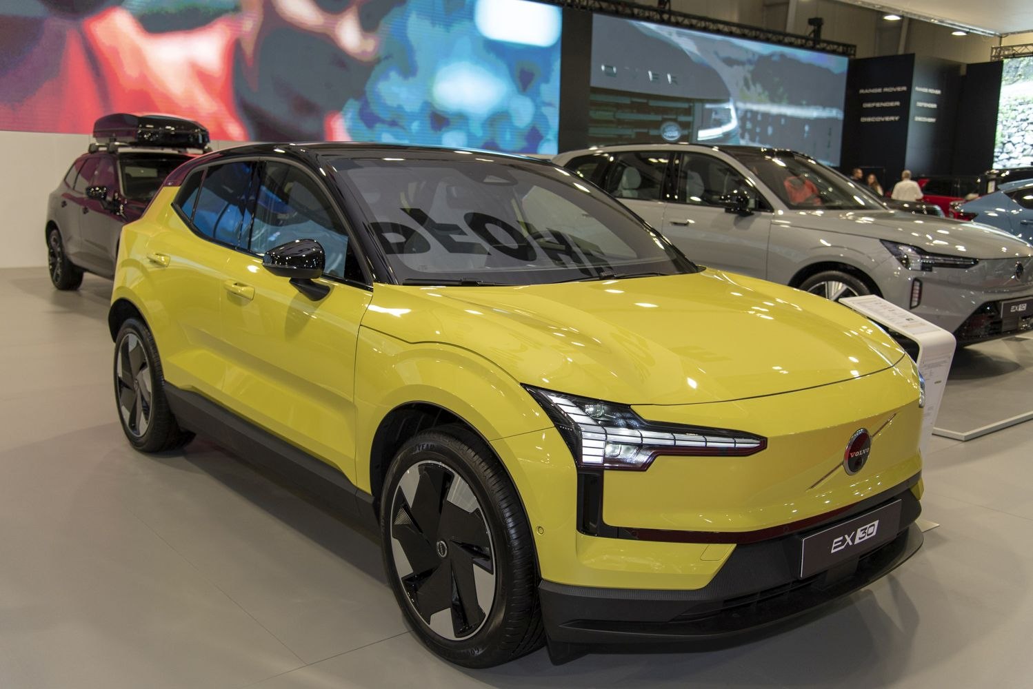 Yellow electric compact SUV with black roof and distinctive LED headlights