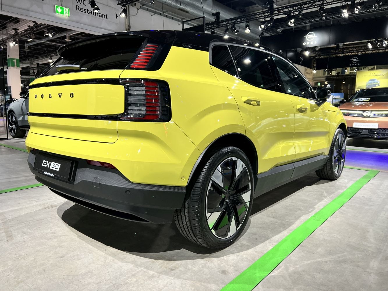 Rear and side view of an electric SUV with vertical tail lights and aerodynamic wheels