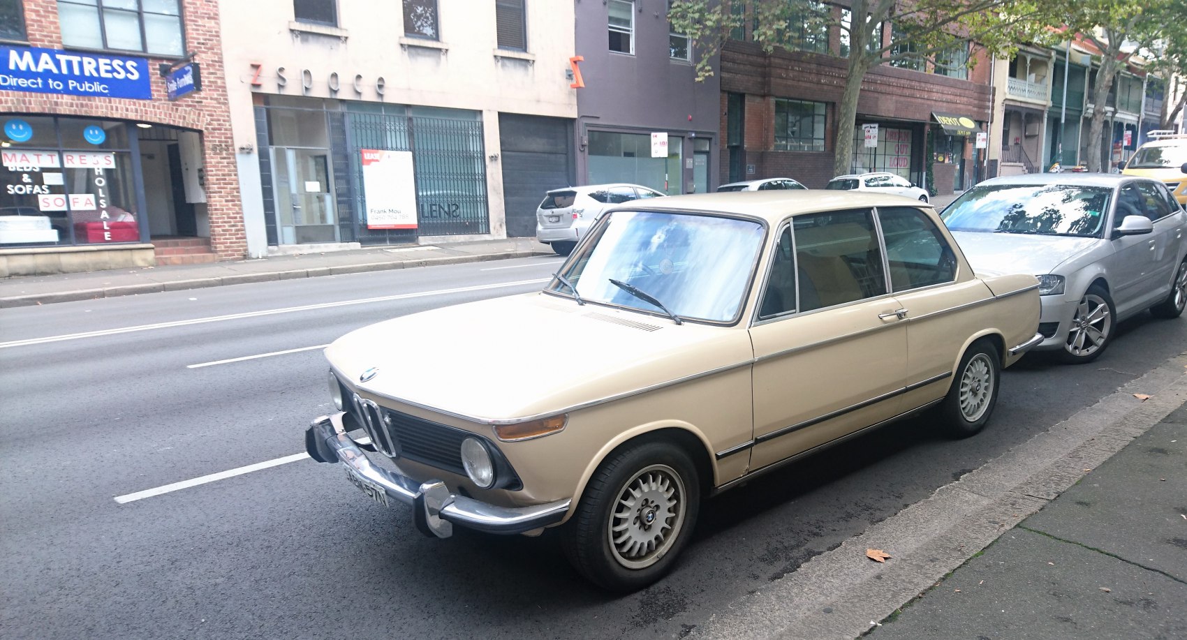 Vintage two-door sedan with round headlights and chrome front bumper