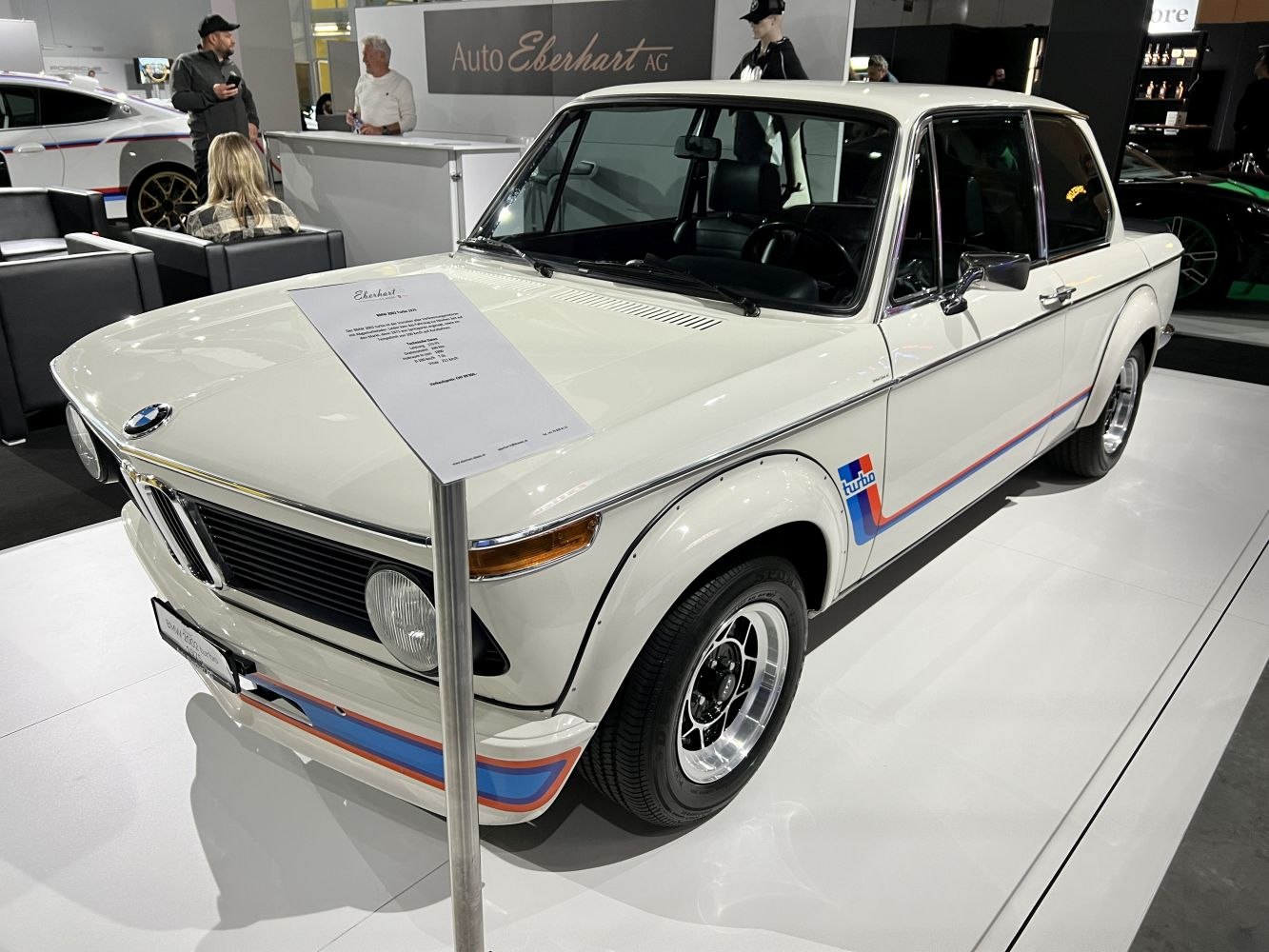 White classic coupe with M stripes and chrome wheels