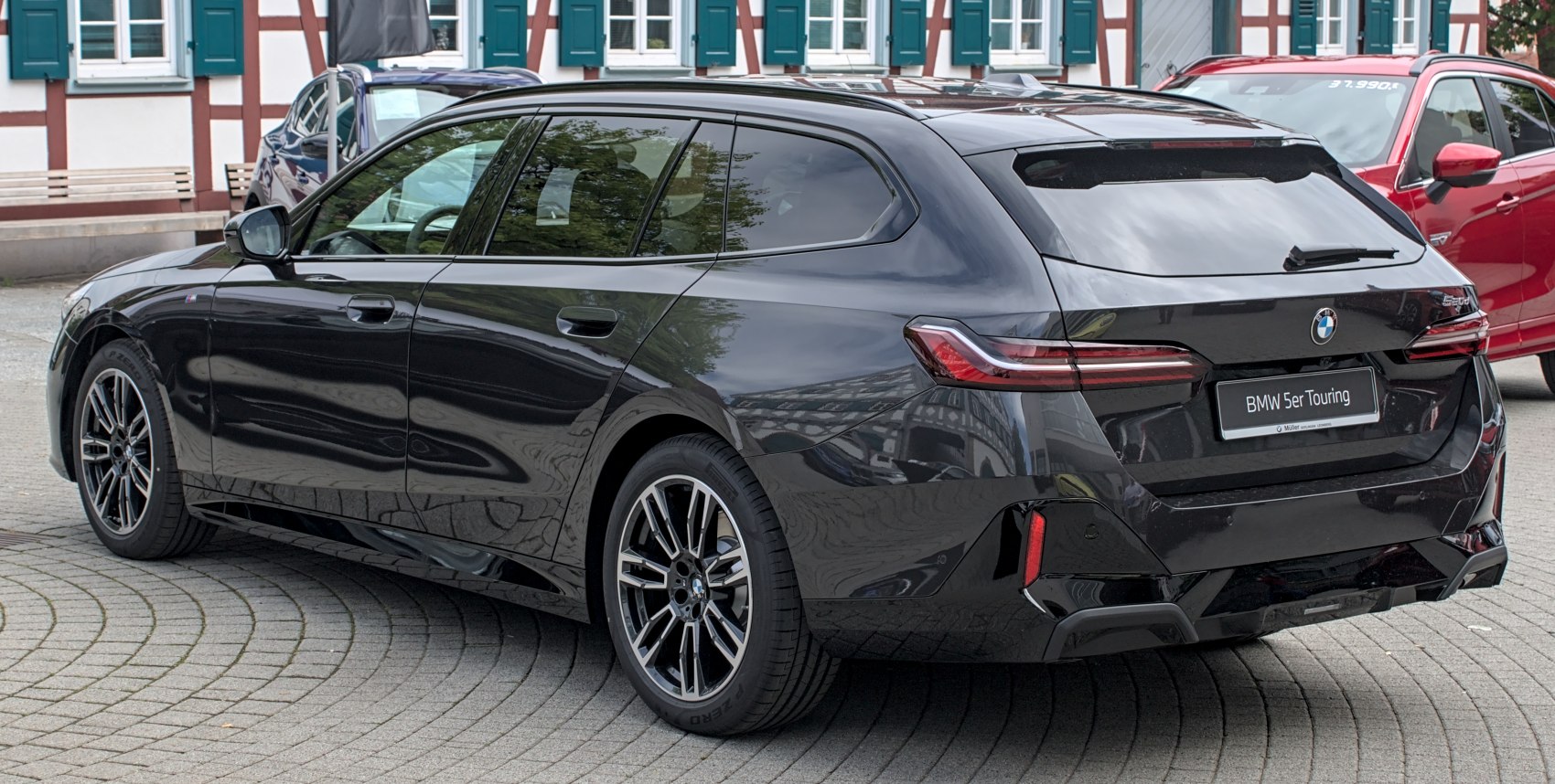 Black station wagon with sleek rear design and alloy wheels