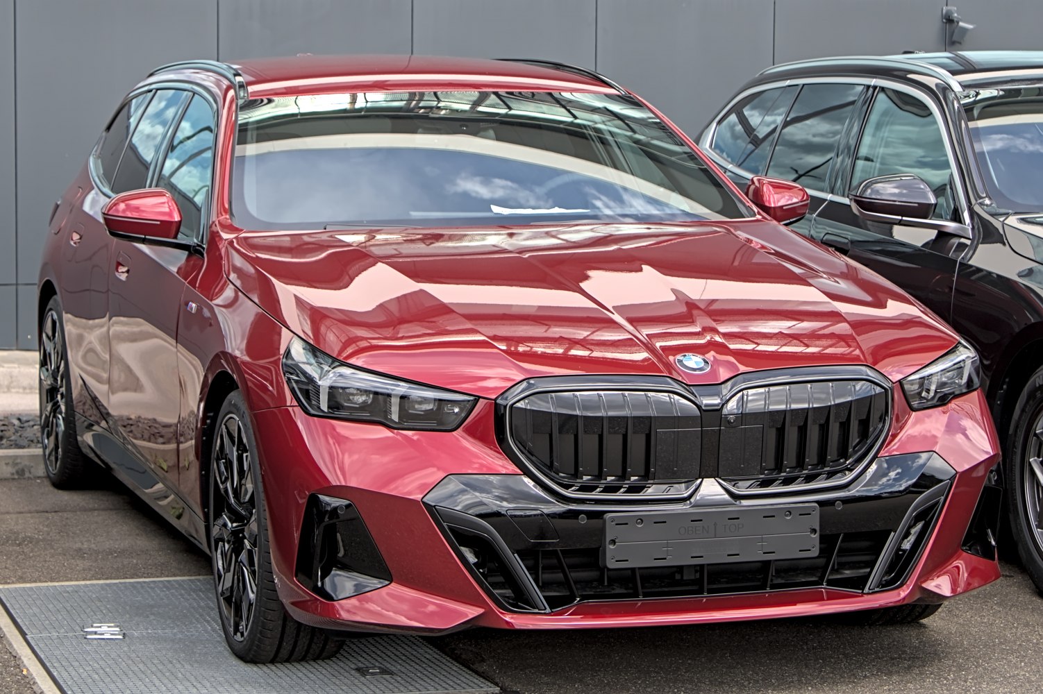 Front grille and LED headlights of a sporty red station wagon