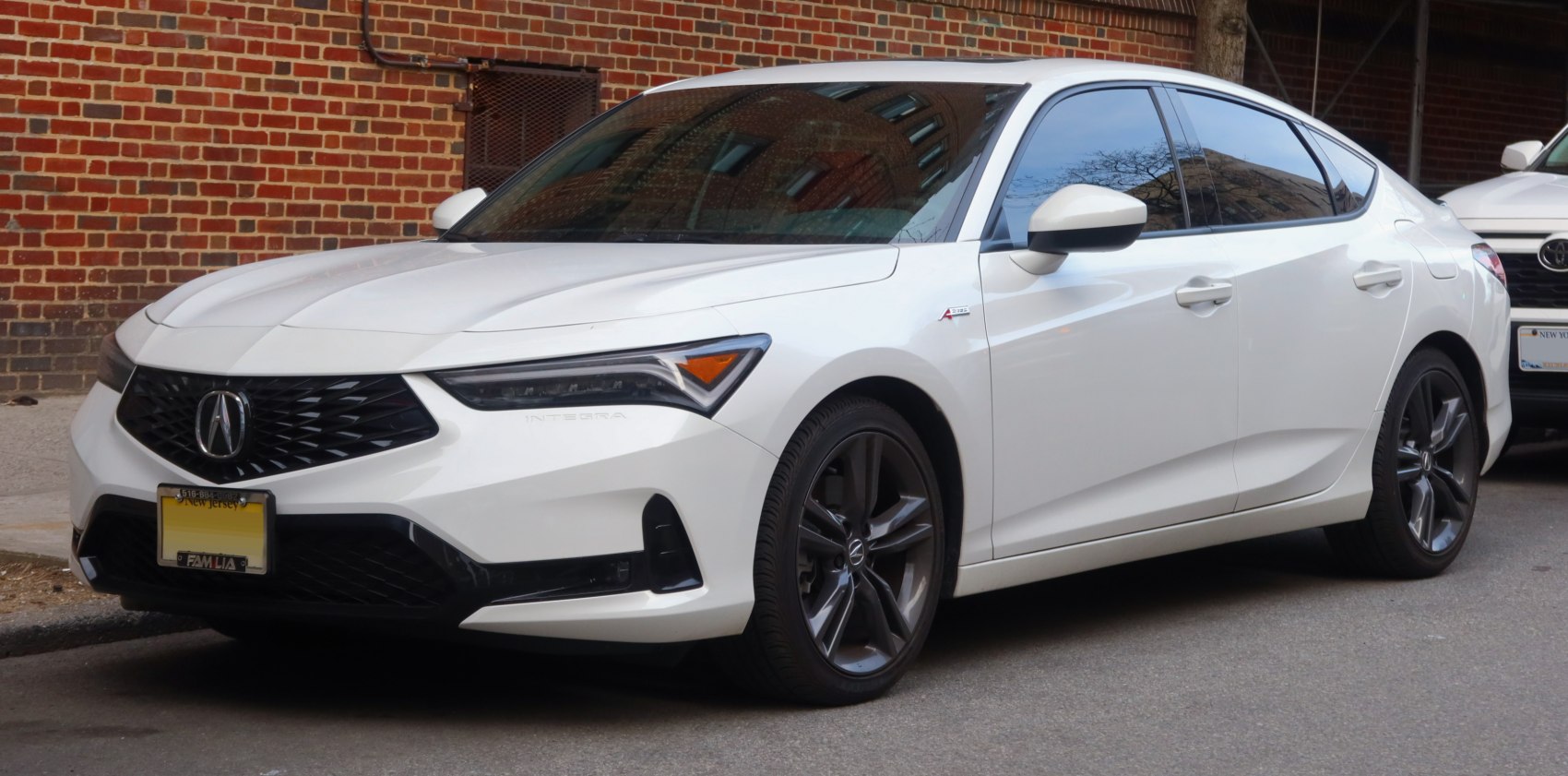 Front side profile showing sporty grille and sleek sedan design