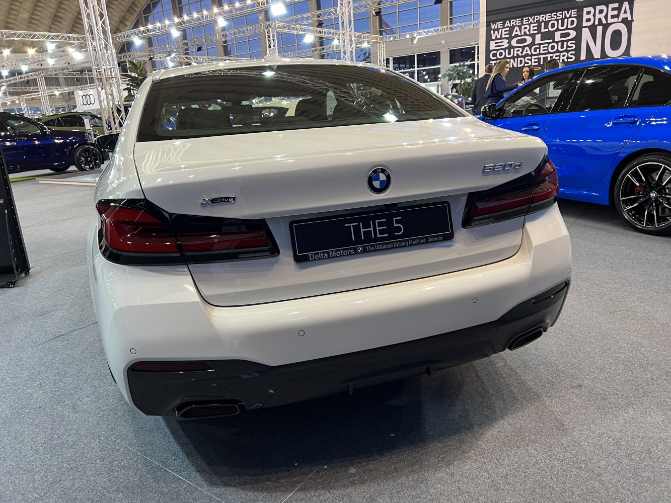 Rear view with tail lights, xDrive badge, and dual exhausts of a mid-size luxury sedan