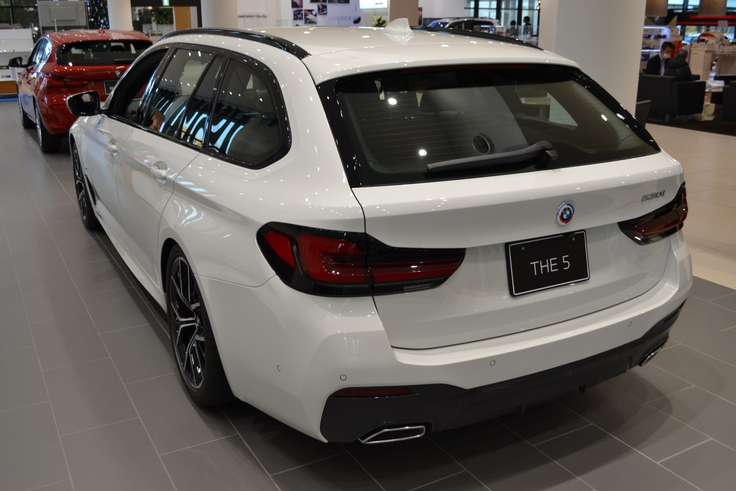 Rear view of BMW 5 Series Touring with facelift taillights and dual exhausts
