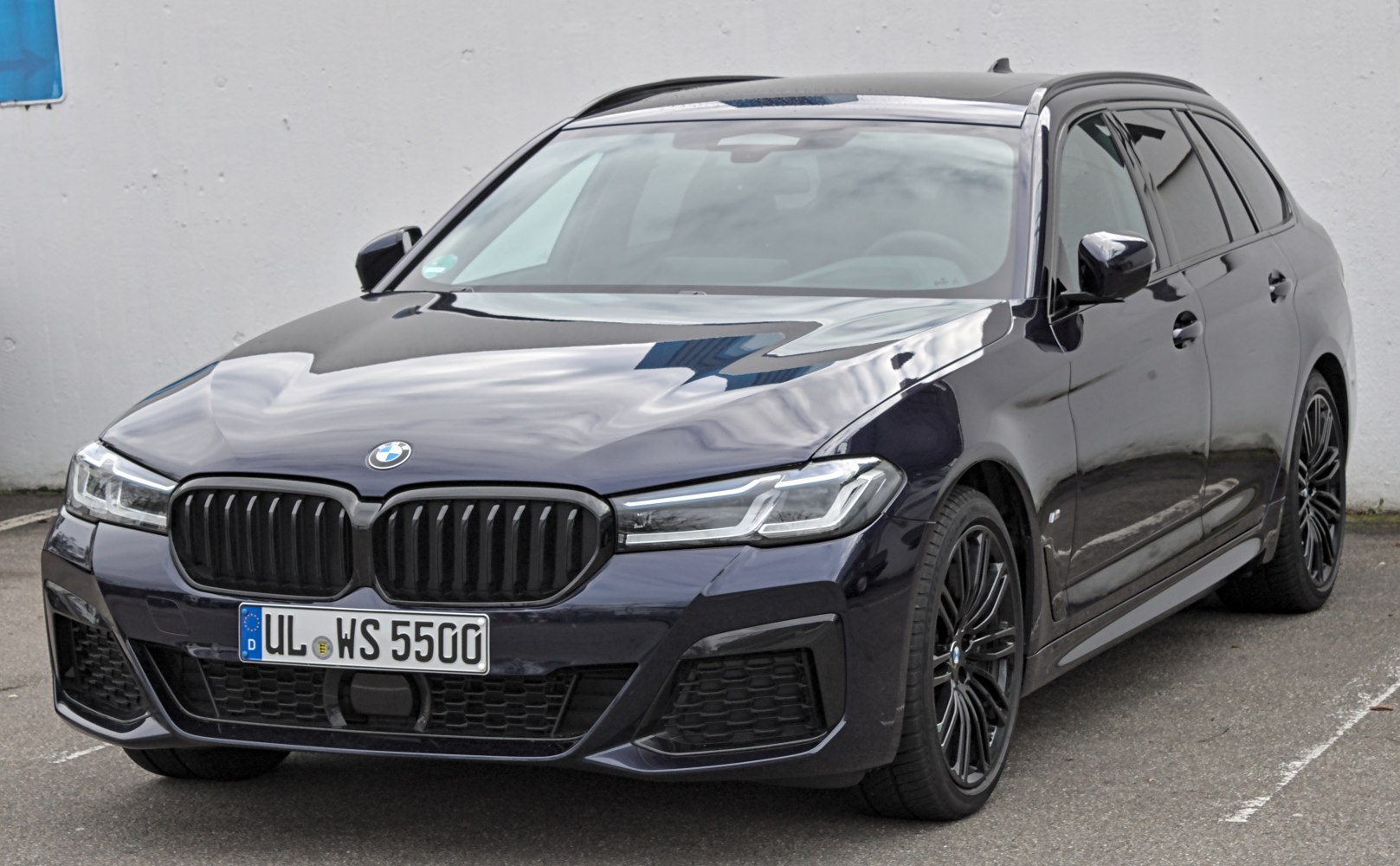 Front and side view of luxury estate with black grille and alloy wheels
