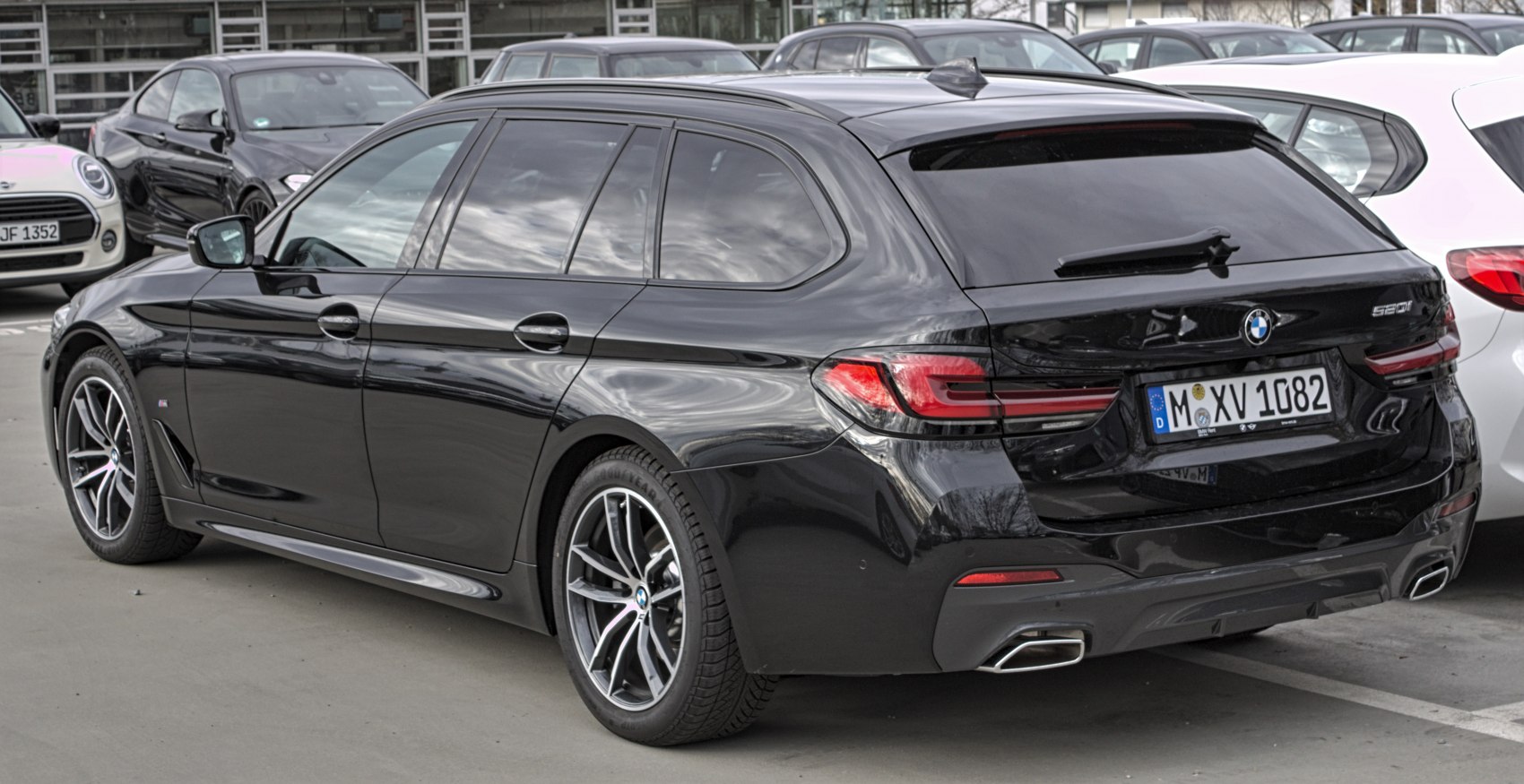 Rear view with sleek taillights and dual exhausts on a black station wagon