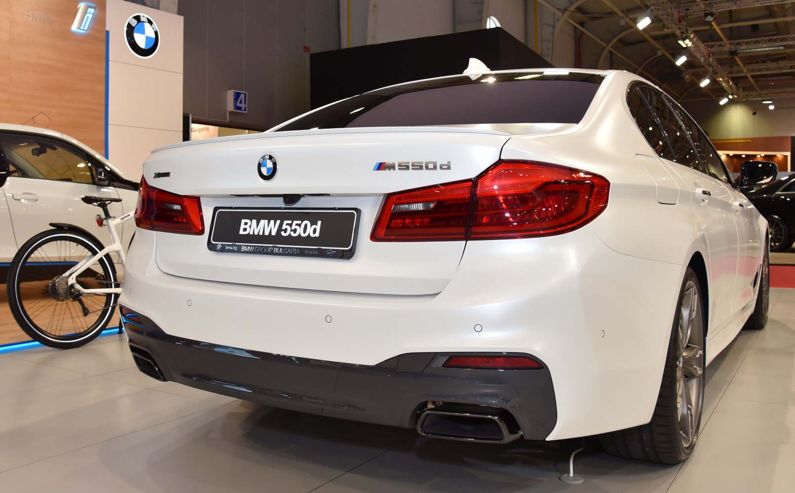 Rear view of a sedan with taillights and dual exhaust outlets