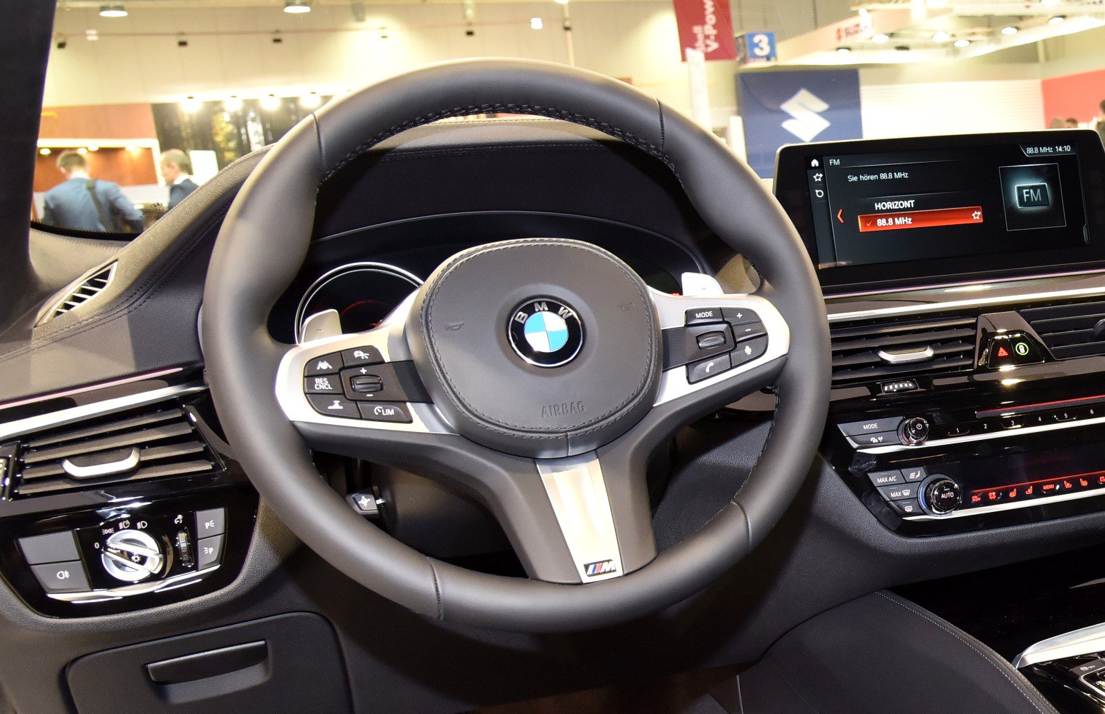 Steering wheel and dashboard controls of a modern luxury sedan