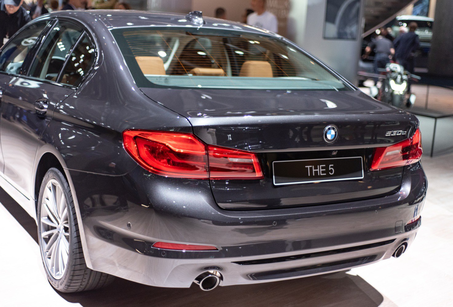 Rear design with tail lights and dual exhaust pipes in a luxury sedan