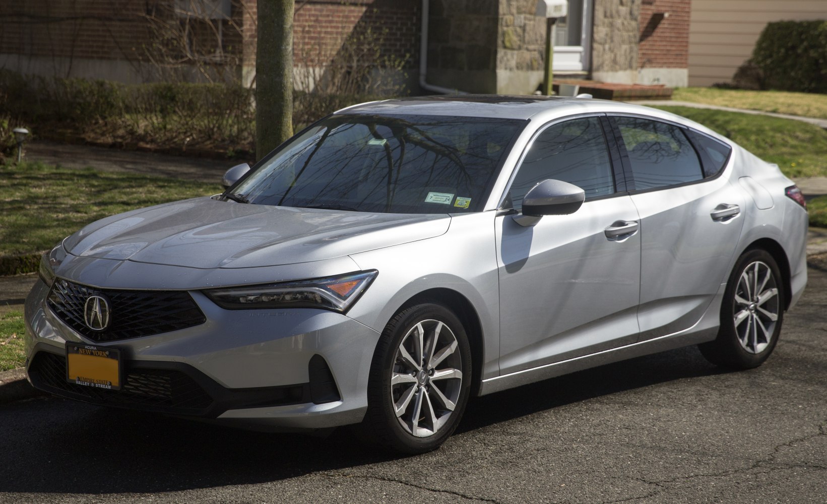 Front-side view with sleek headlamps and aerodynamic body lines.
