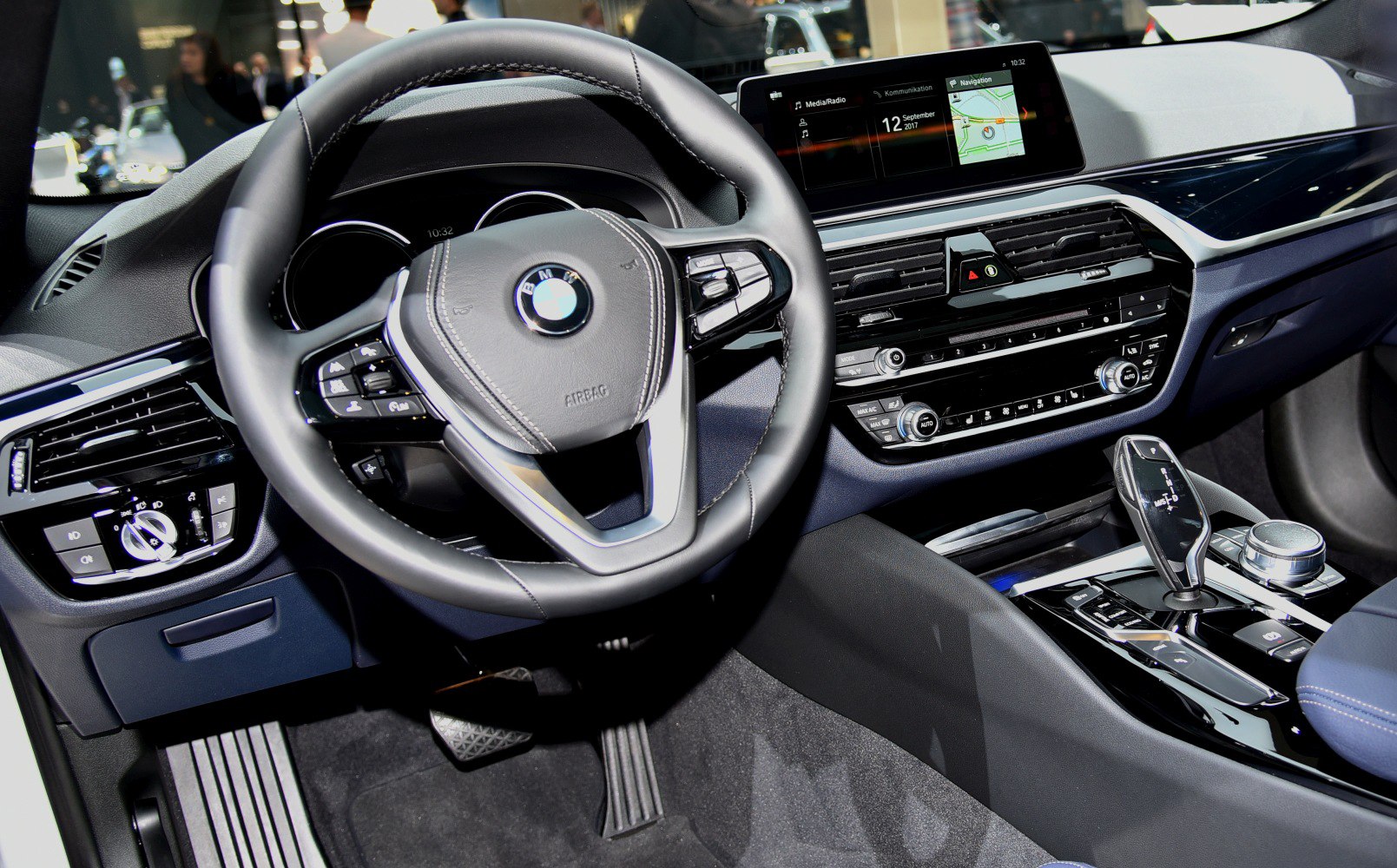Steering wheel, dashboard controls, infotainment screen, gear shift lever
