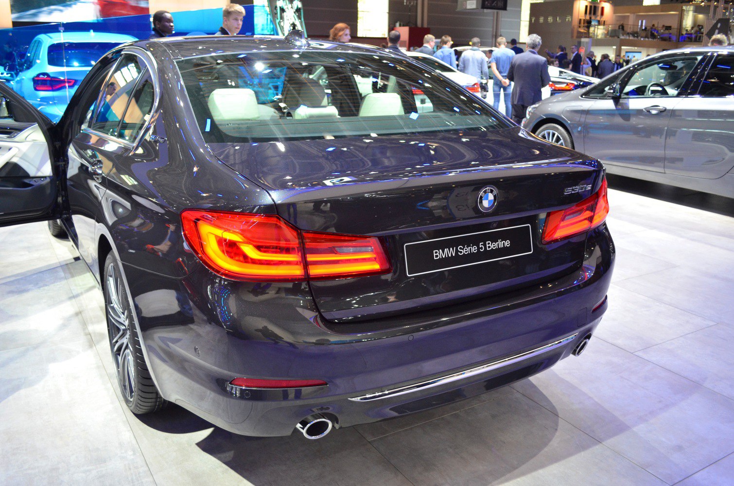 Rear view with illuminated LED tail lights and exhaust pipe