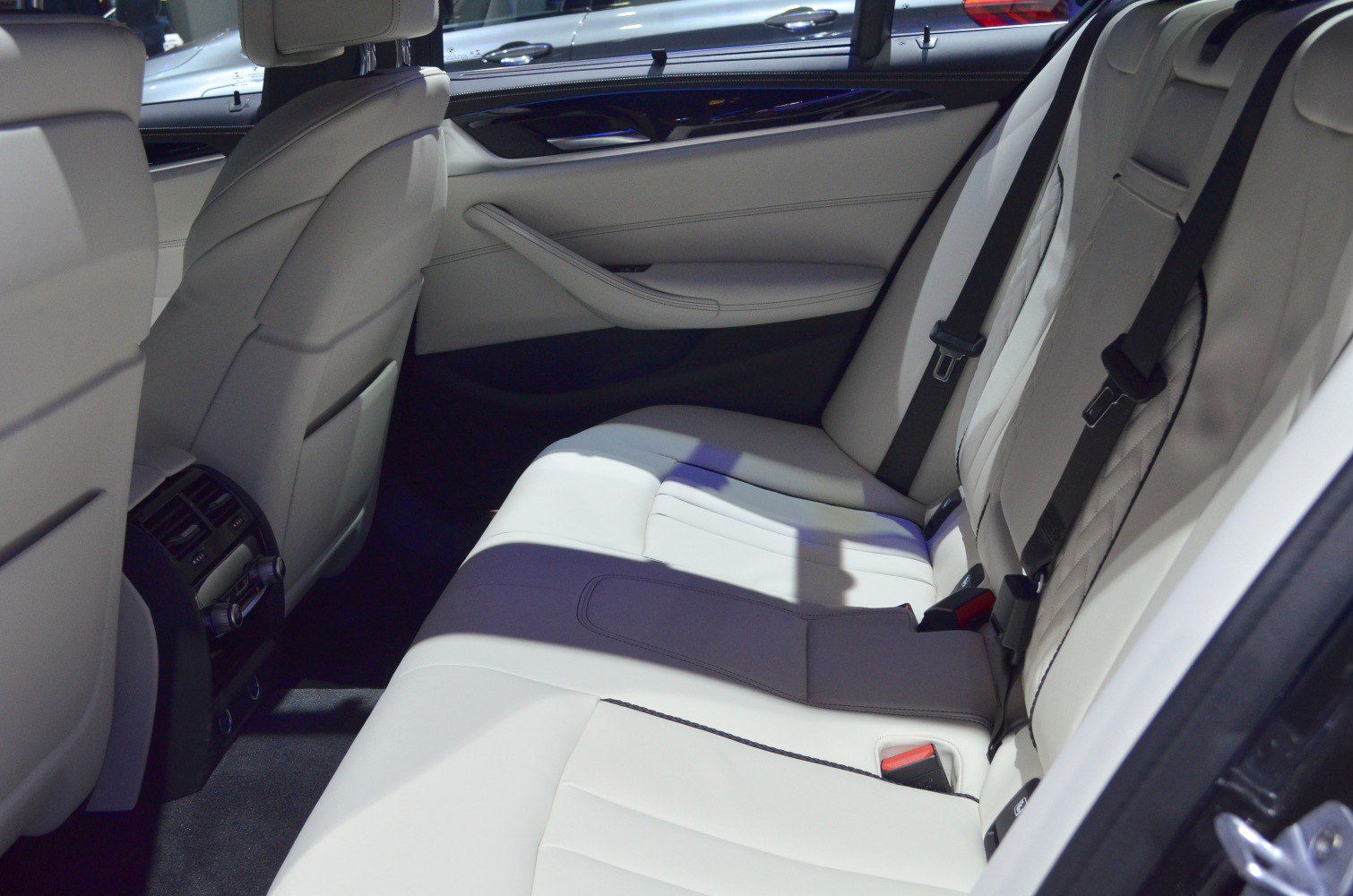 Luxury rear seat interior with spacious leather upholstery and seat belts