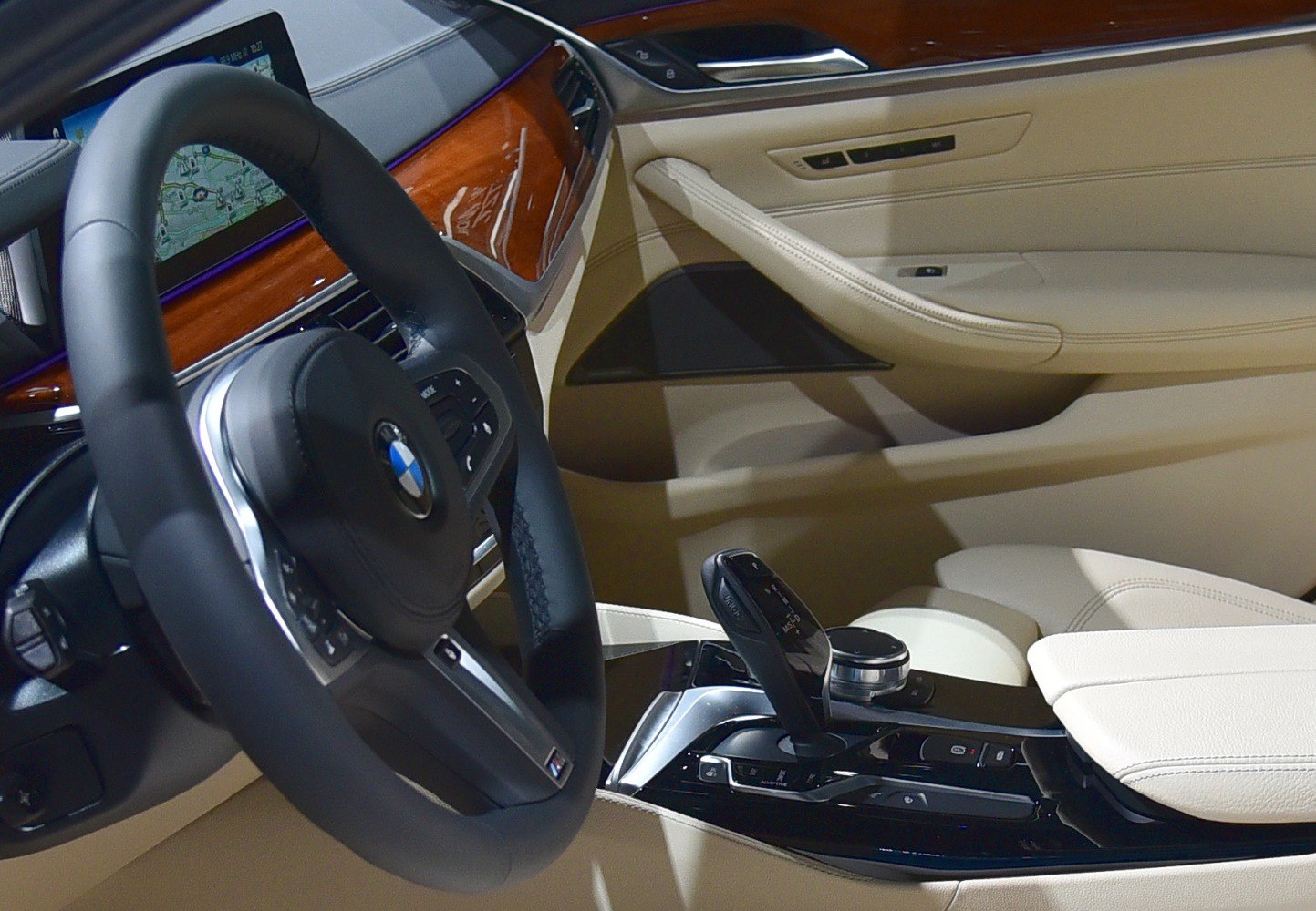 Luxury beige leather interior with wood trim and modern dashboard controls