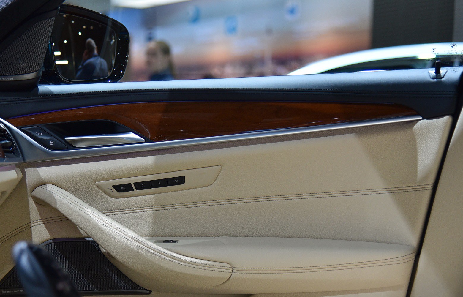Beige leather door panel with wood trim and seat memory buttons