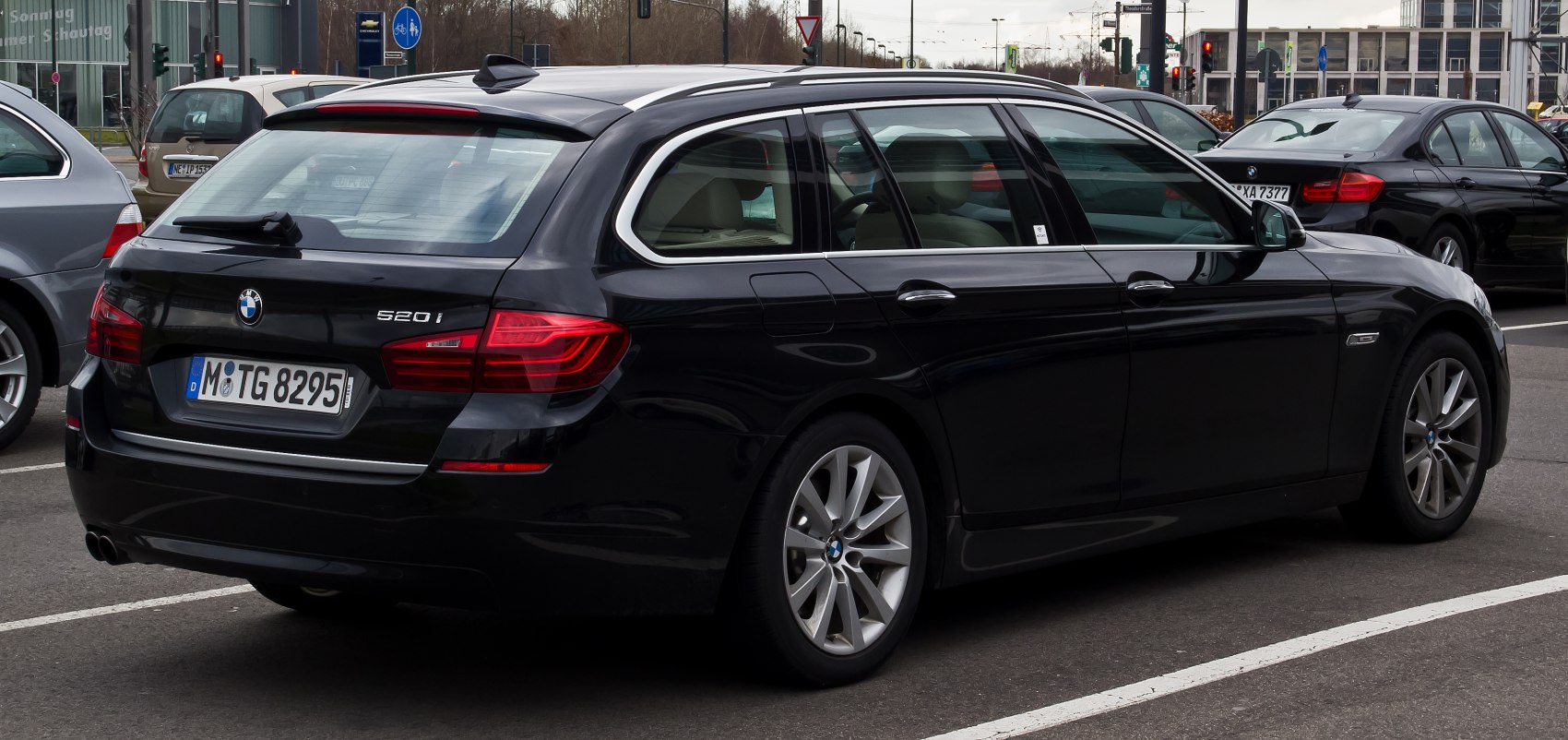 Rear side view of station wagon with taillights and alloy wheels