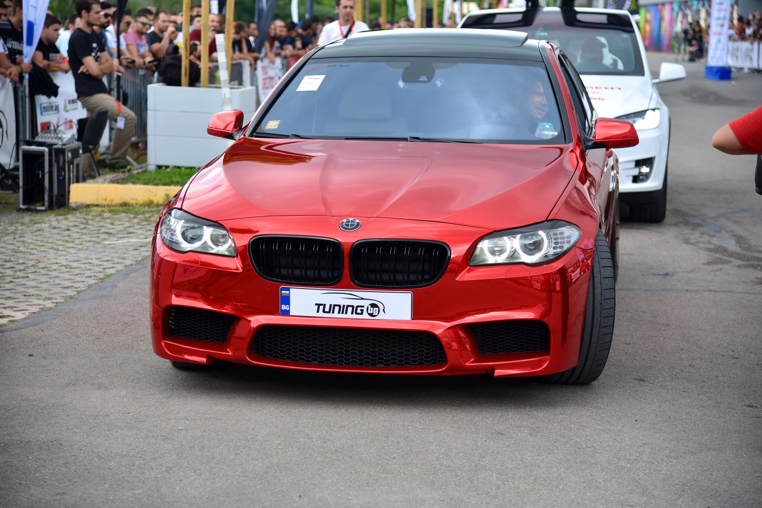 Front view of sport-tuned sedan with LED angel eyes and aggressive grille