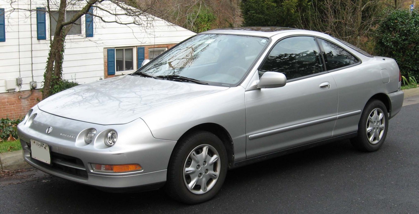 Silver sport coupe with dual round headlights and sleek body lines
