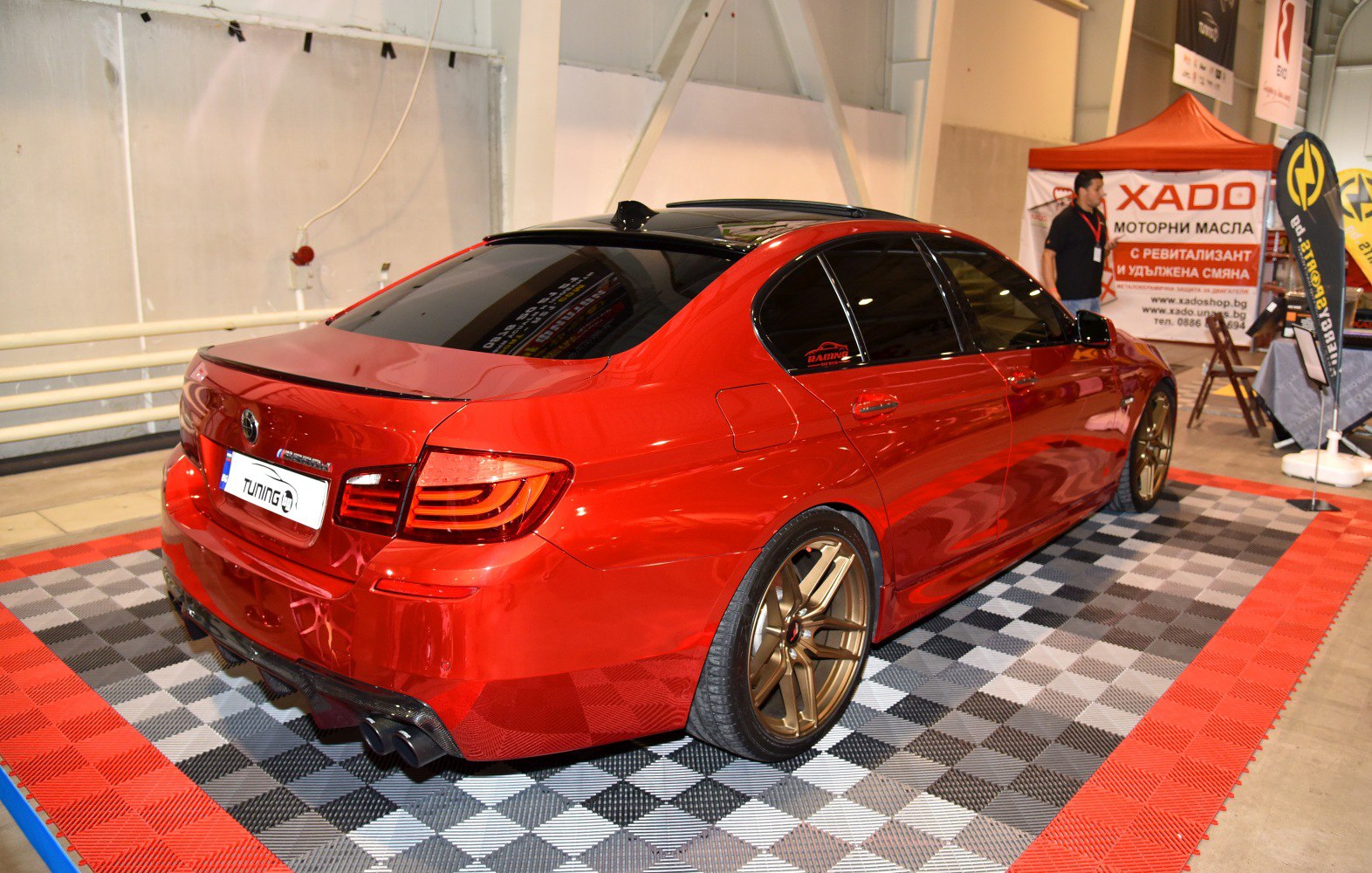 Red sedan with bronze alloy wheels and sporty rear diffuser