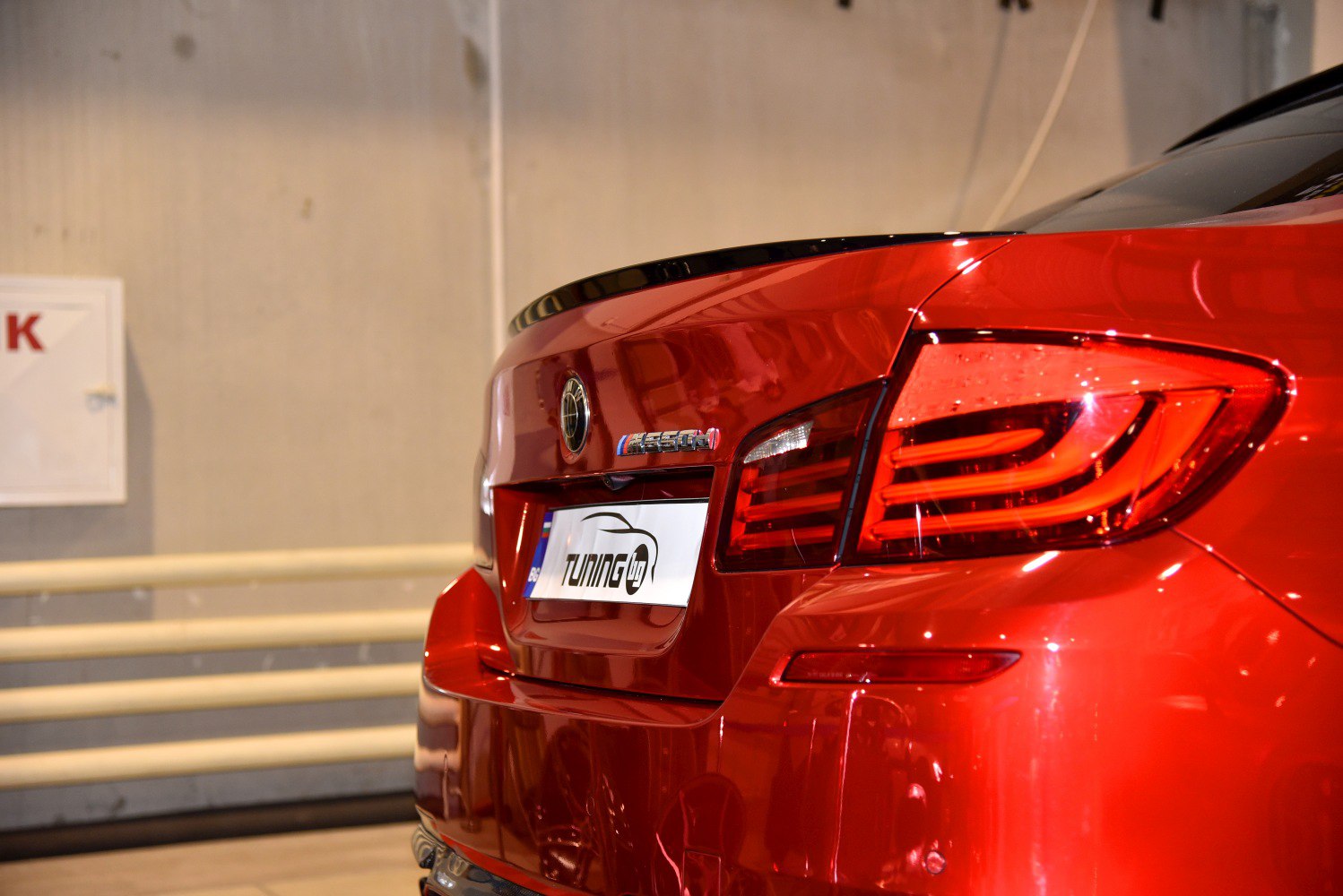 Close-up of rear taillight and trunk design in red vehicle