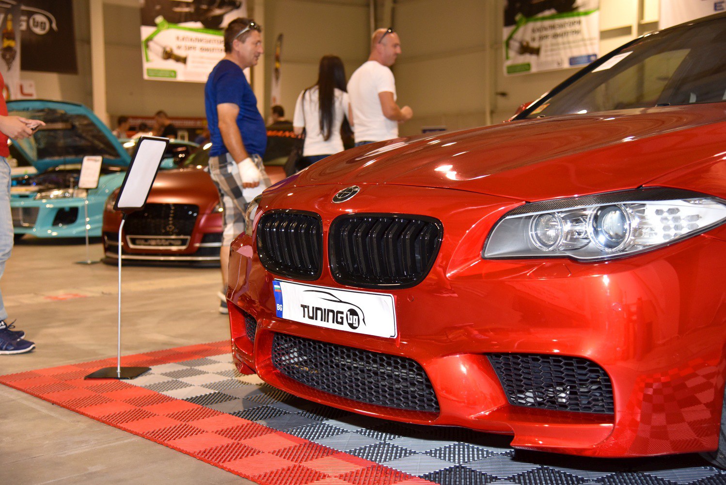 Close-up of red car front grille and headlight