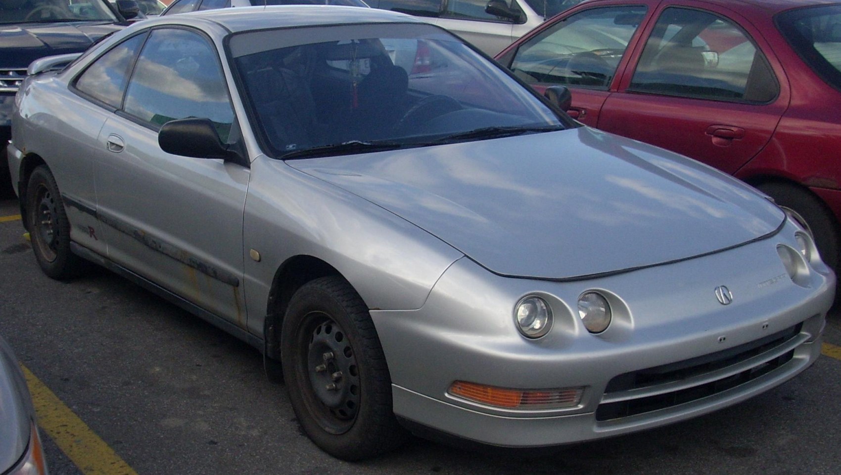 Silver coupe with quad circular headlights and steel rims