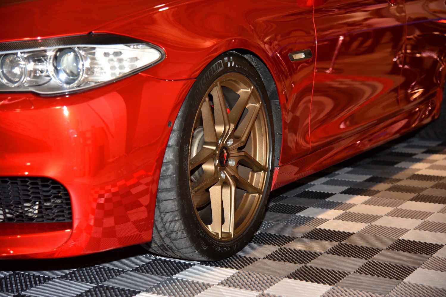 Front headlight and bronze alloy wheel close-up