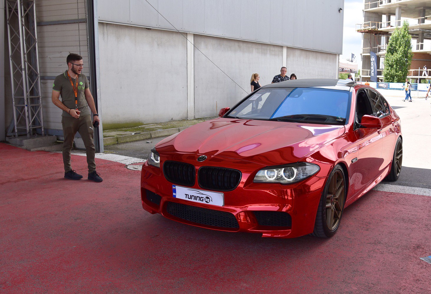 Red sedan with black grille and bronze alloy wheels