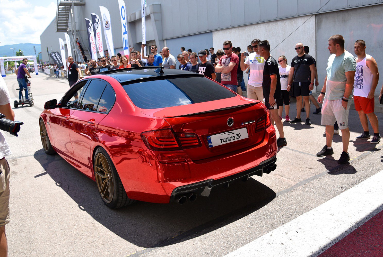Red sedan with black roof and bronze wheels
