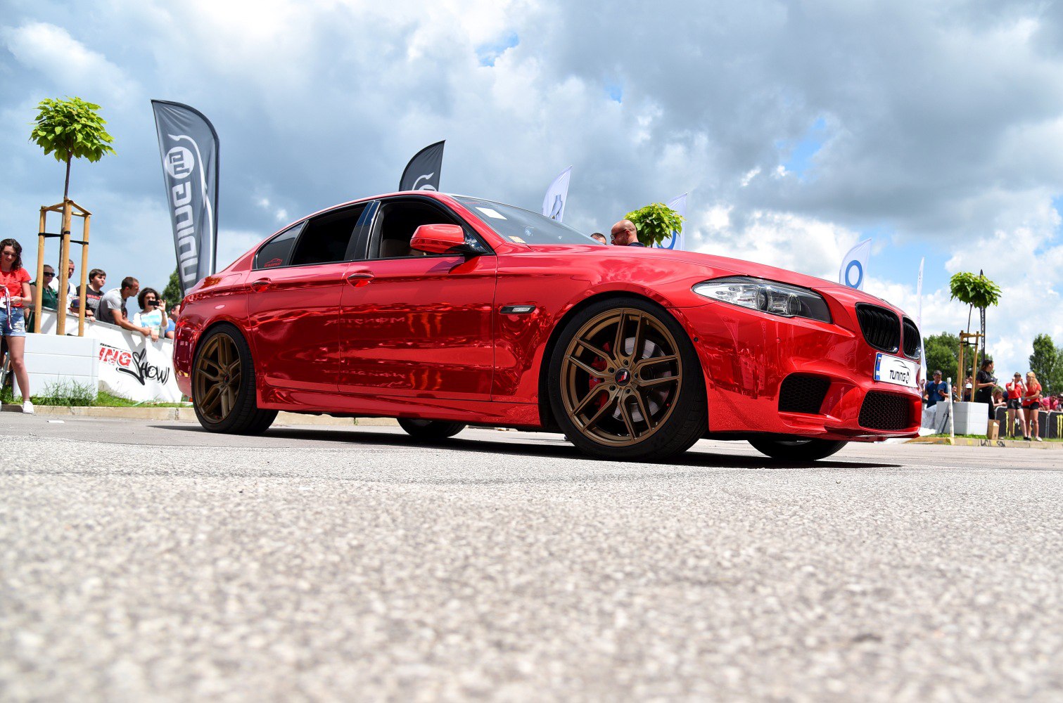 Red sedan with bronze alloy wheels and lowered suspension
