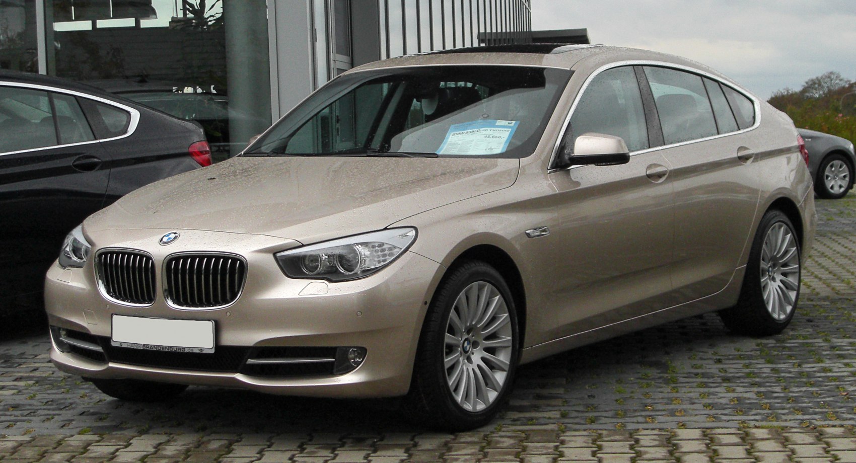 Front and side view of a luxury hatchback with kidney grille and sleek headlights