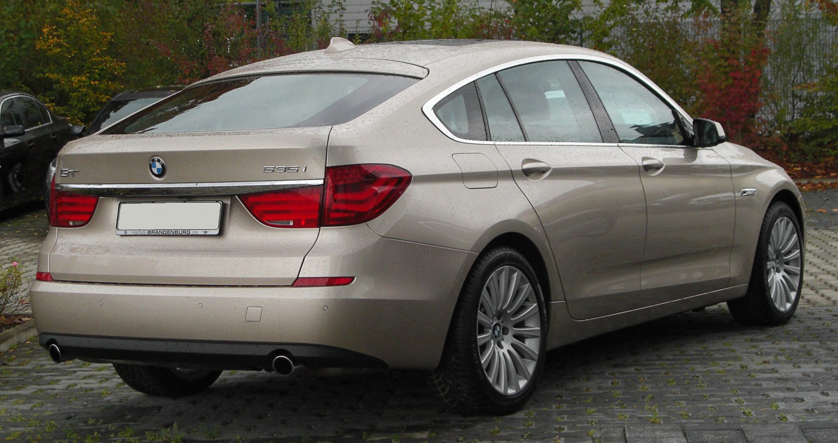 Rear and side view of a hatchback with dual exhaust and distinctive taillights