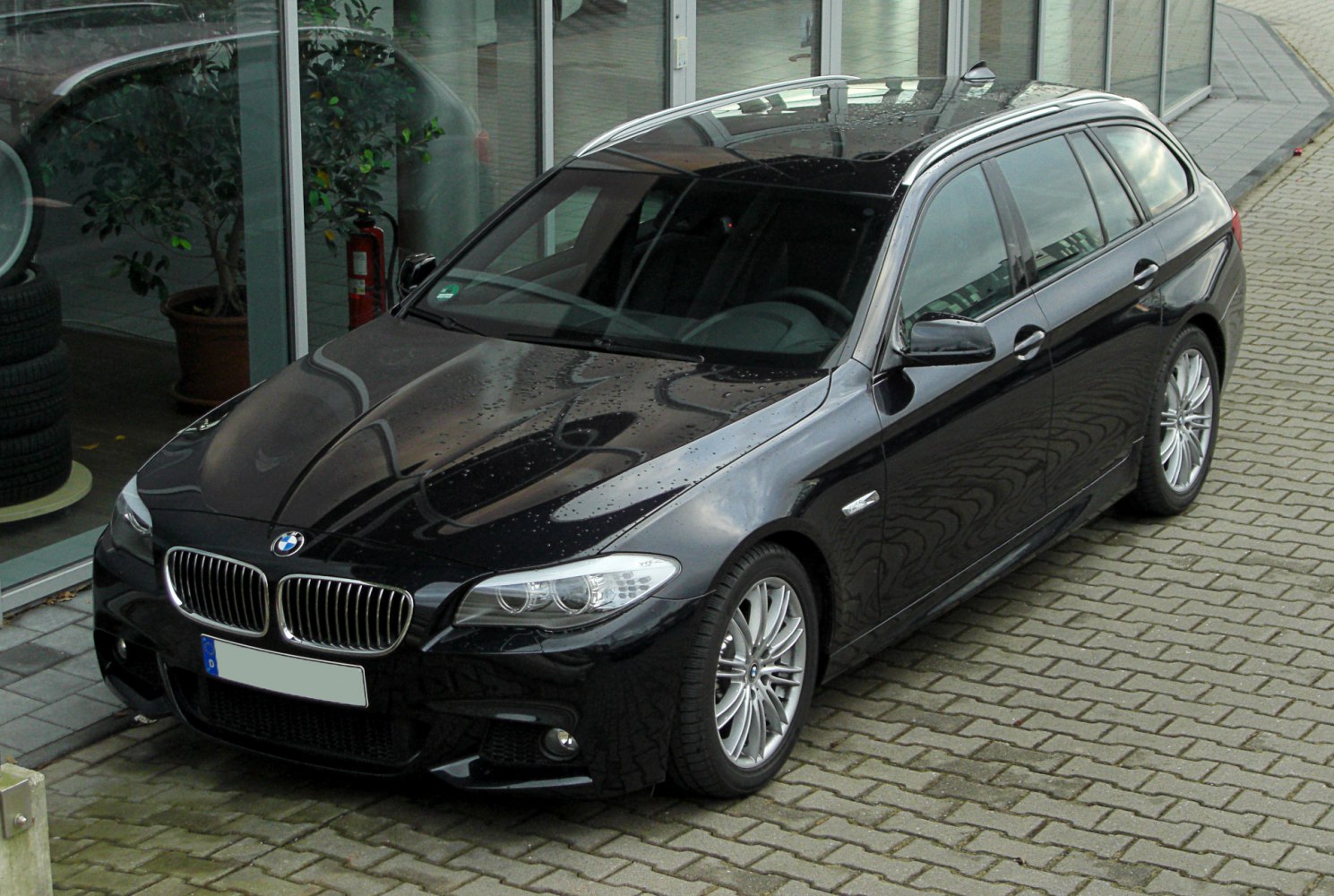 Front-angle of black wagon with sport grille and sleek design