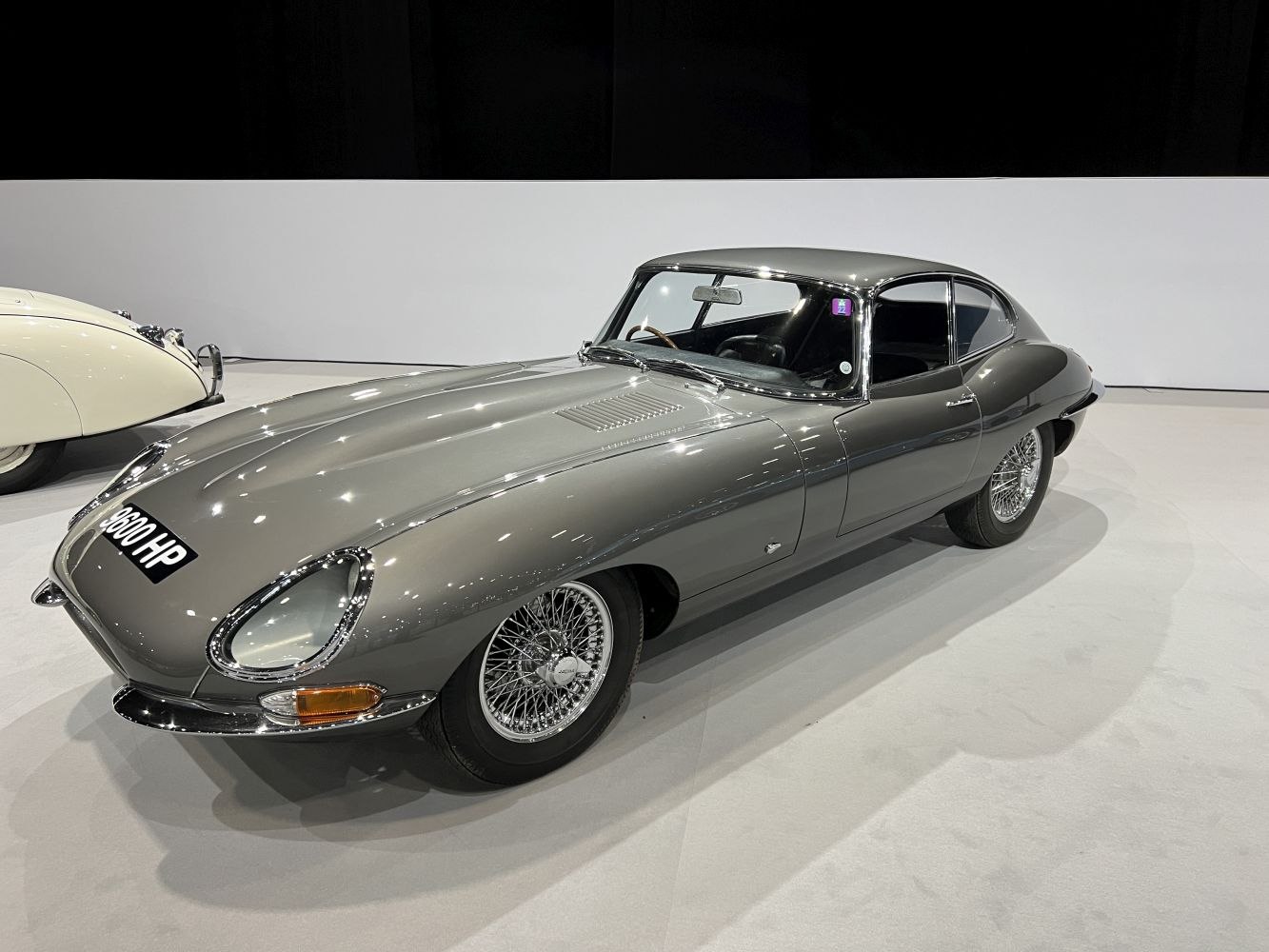 Smooth streamlined body and wire-spoke wheels of a vintage coupe