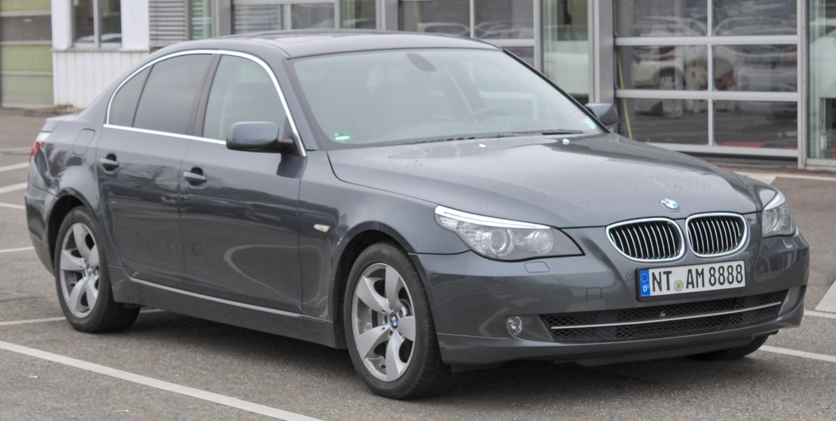 Front-side view with kidney grille and projector headlights.