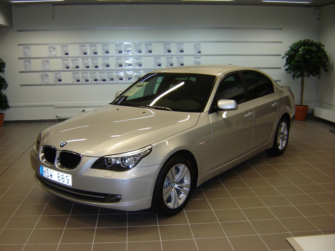 Front and side exterior view of a silver luxury sedan