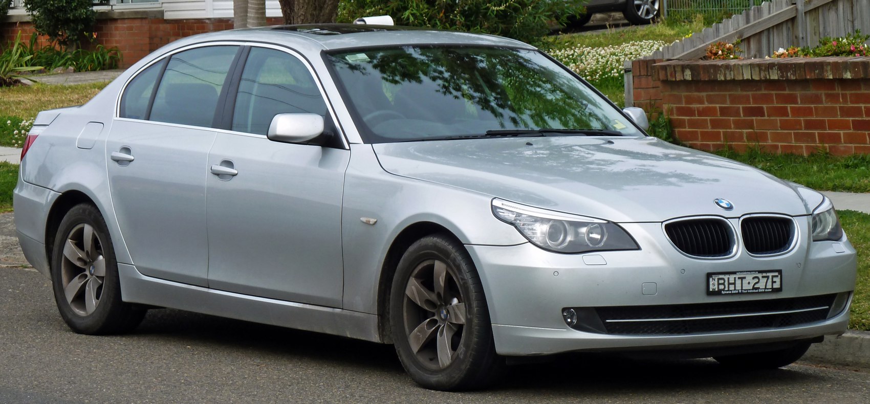 Silver sedan with facelifted headlights and kidney grille