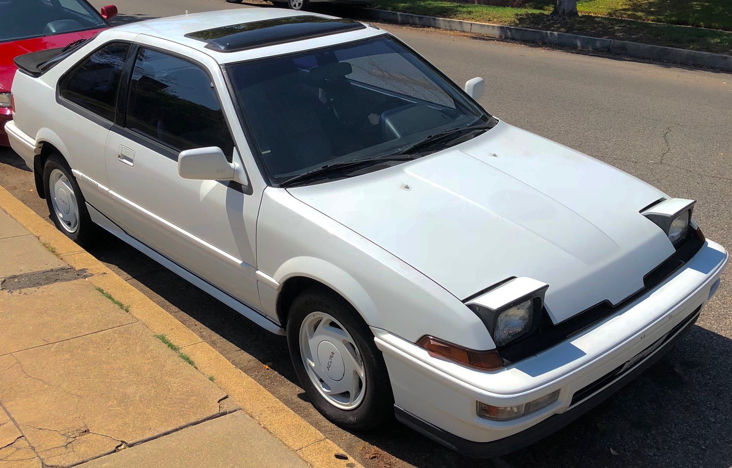 Pop-up headlights and sunroof on a late 1980s compact coupe