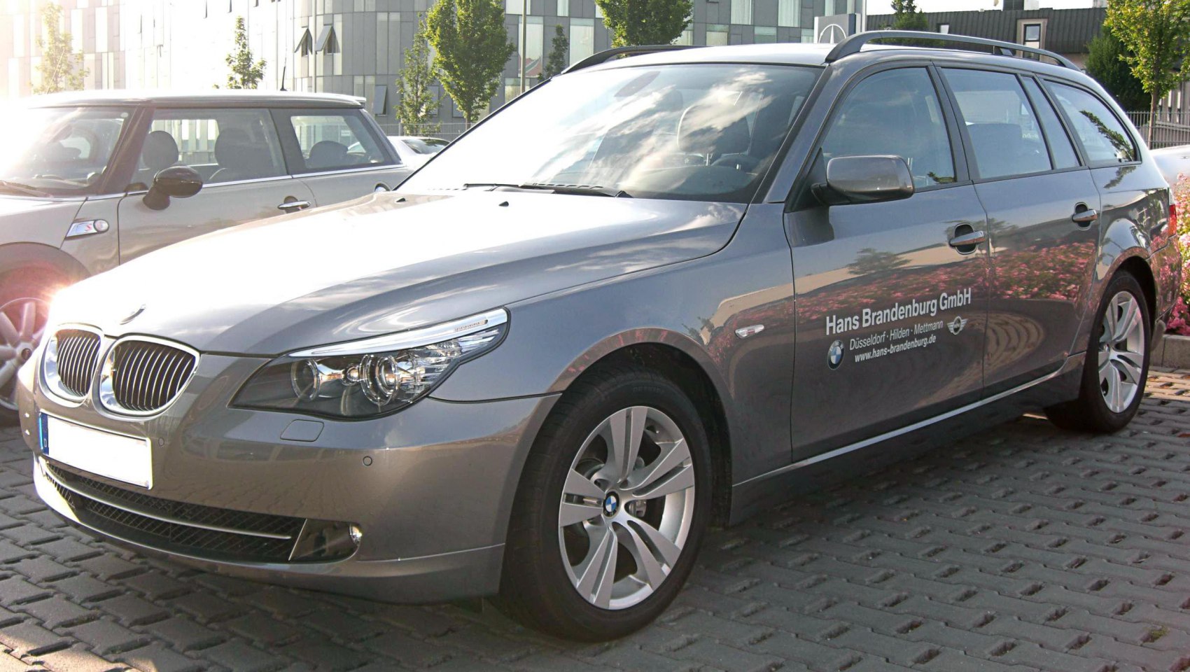 Front and side view of station wagon with distinctive headlights and alloy wheels