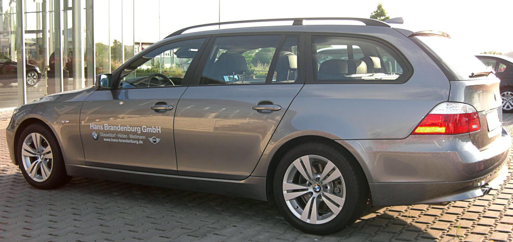 Silver estate car with rear side view and alloy wheels