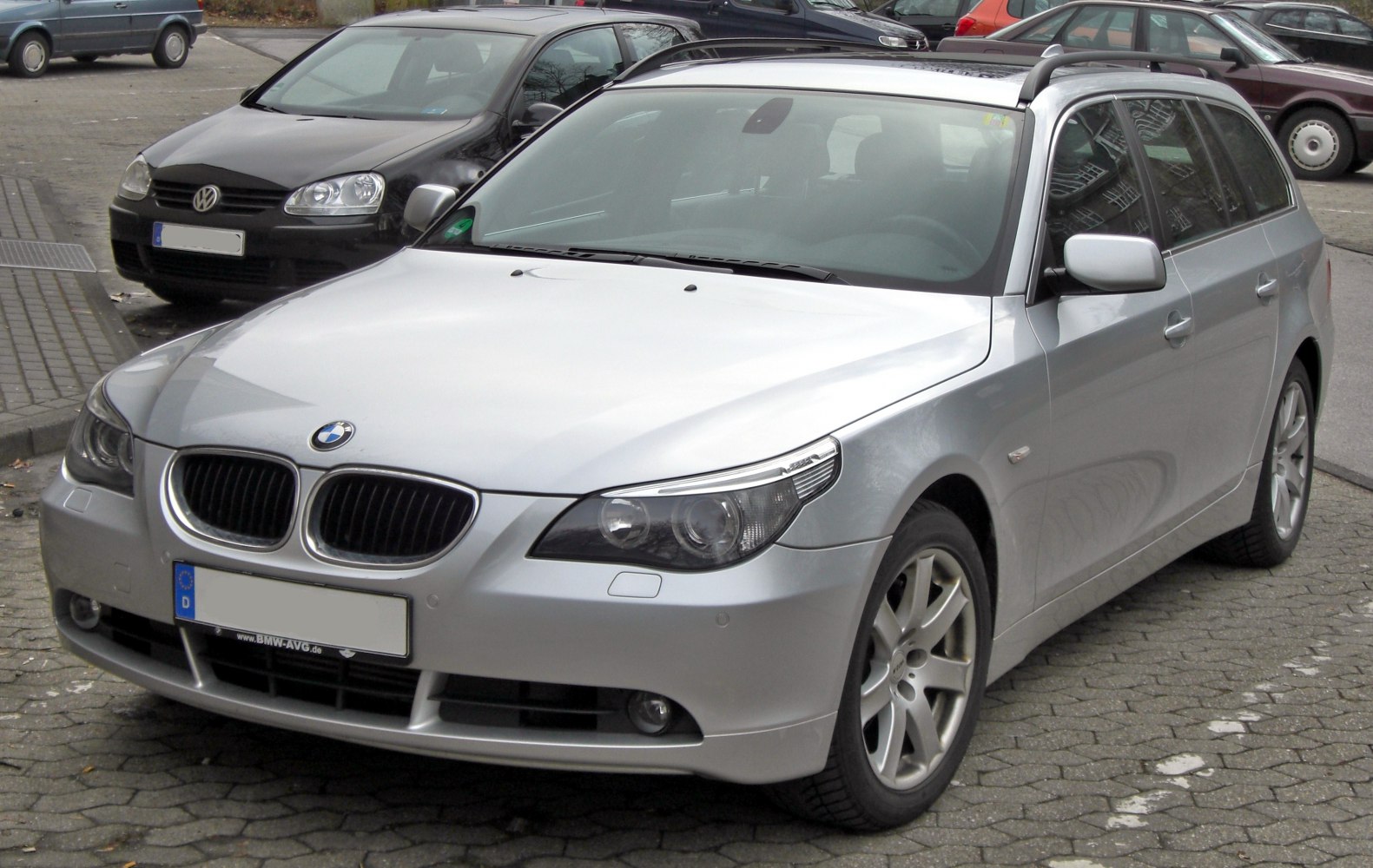 Silver station wagon with kidney grille and roof rails