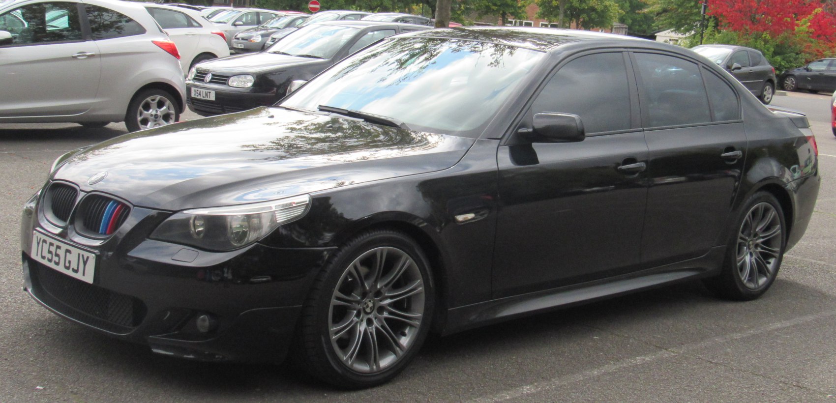Front side view of a sedan with alloy wheels and tinted windows