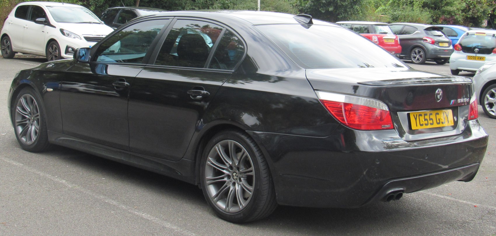 Rear side view with alloy wheels and dual exhausts