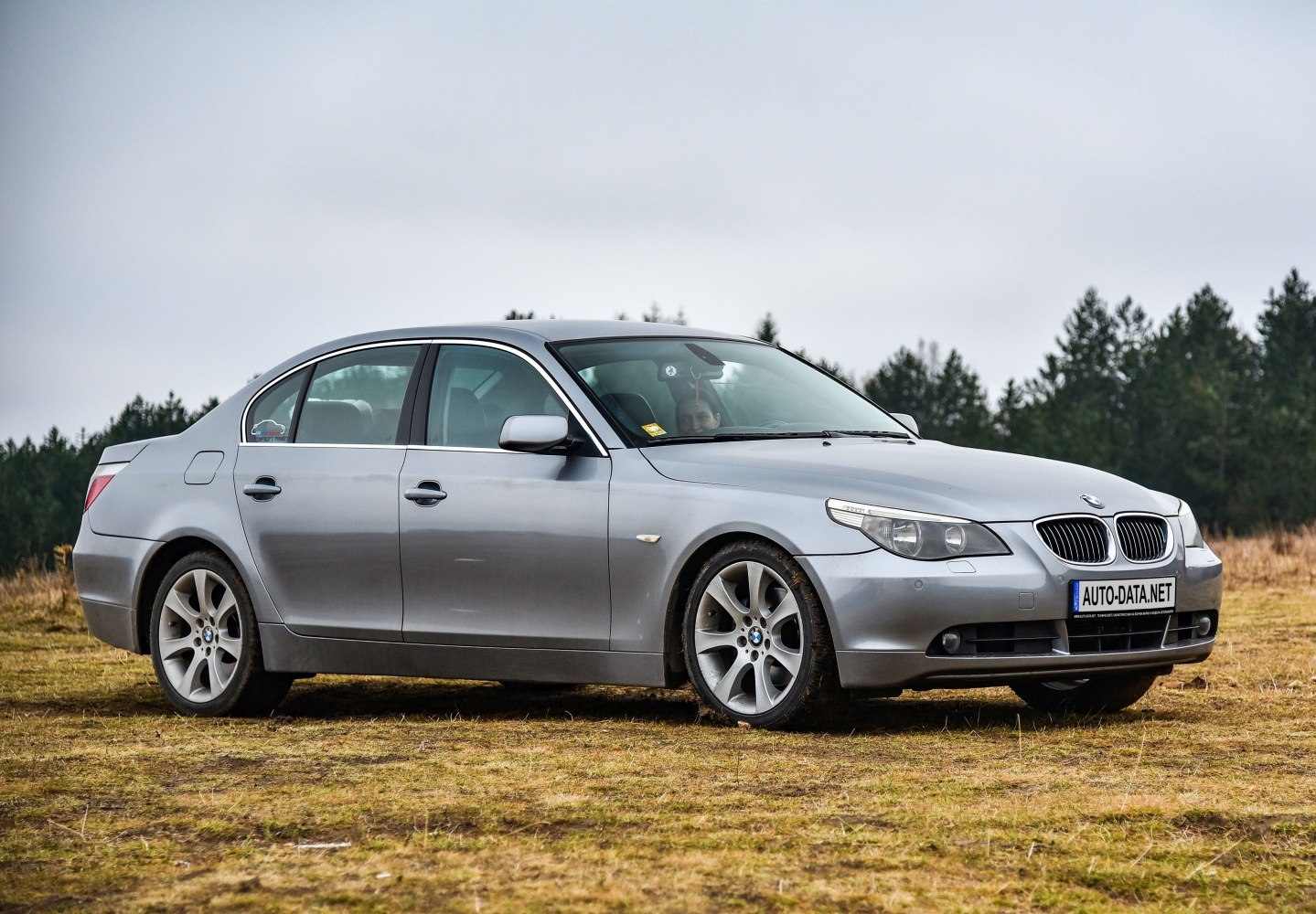 Side profile of a luxury sedan with alloy wheels and distinct headlights