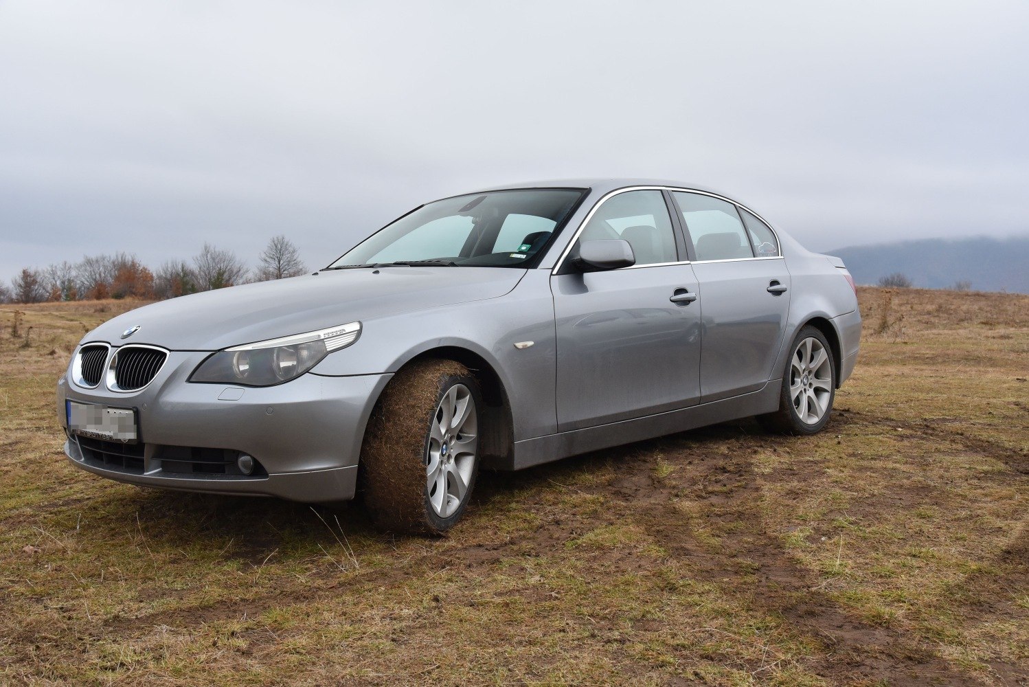 Silver sedan with front side profile on rough terrain