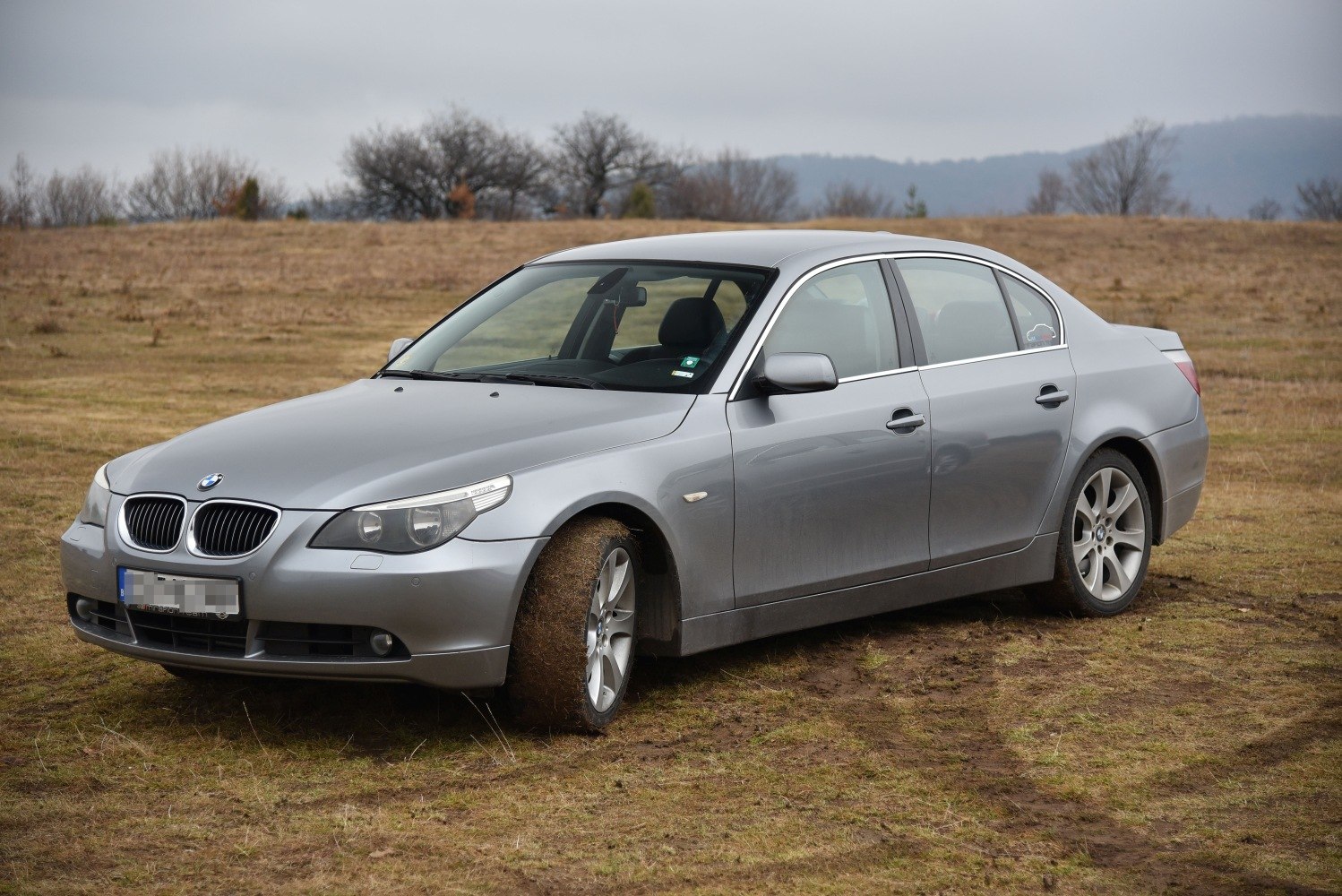 Silver sedan with kidney grille and alloy wheels parked outdoors