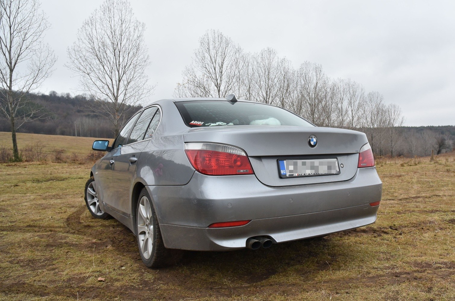 Rear view of sedan with dual exhaust and distinctive tail lights