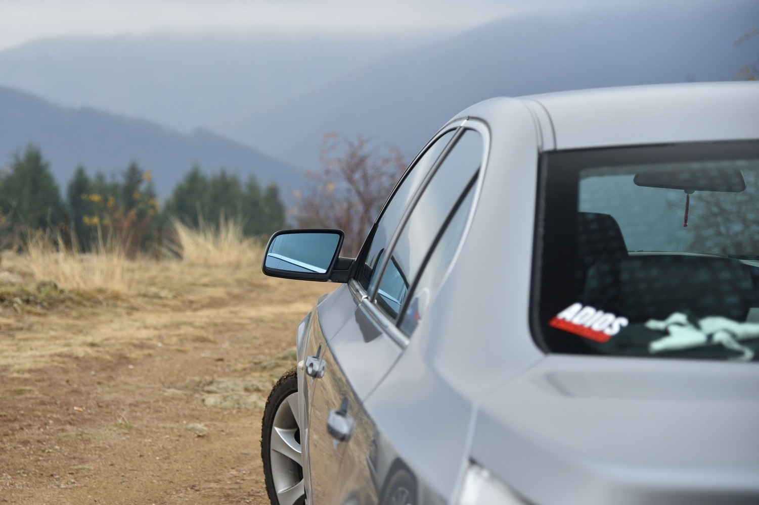 Rear side view showing alloy wheel and side mirror reflection.